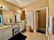 Bathroom featuring dual sinks, a large mirror, and ample counter space for convenient storage and organization at 4368 Fox Glen Loop, Kissimmee, FL 34746