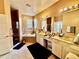 Well-lit bathroom features dual sinks, a soaking tub, and a glass-enclosed shower for a spa-like experience at 4368 Fox Glen Loop, Kissimmee, FL 34746