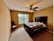 Bedroom with a ceiling fan, carpeted floors, and a window view at 4368 Fox Glen Loop, Kissimmee, FL 34746