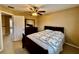 Bedroom with a ceiling fan, carpeted floors and a dresser with a mirror at 4368 Fox Glen Loop, Kissimmee, FL 34746