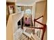 Bright foyer with a high ceiling and a carpeted staircase with white banisters and double doors at 4368 Fox Glen Loop, Kissimmee, FL 34746