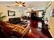 Spacious living room boasts hardwood floors, ceiling fans, and a decorative stone accent wall for added appeal at 4368 Fox Glen Loop, Kissimmee, FL 34746