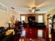 Inviting living room features hardwood floors, a decorative stone accent wall, and ample natural light from windows at 4368 Fox Glen Loop, Kissimmee, FL 34746