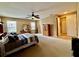 Spacious main bedroom offers a ceiling fan, neutral carpet, and ample natural light for a relaxing retreat at 4368 Fox Glen Loop, Kissimmee, FL 34746