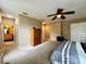 Large main bedroom with neutral carpet, ceiling fan, and a walk-in closet for generous storage space at 4368 Fox Glen Loop, Kissimmee, FL 34746
