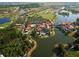 Stunning aerial view of the community showcasing golf course, waterfront properties, and lush landscaping at 516 Millifiora Ln, Kissimmee, FL 34759