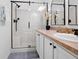 Bathroom featuring a glass-enclosed shower with a seat, a vanity with a sink, and tile flooring at 516 Millifiora Ln, Kissimmee, FL 34759