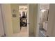 This image showcases a walk-in closet and a bathroom with a glass-enclosed shower and neutral walls at 516 Millifiora Ln, Kissimmee, FL 34759