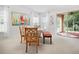Inviting dining room featuring a white table set, bright windows, and a seamless transition to the patio at 516 Millifiora Ln, Kissimmee, FL 34759