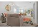 Open-concept living room with ample seating, a colorful rug, and natural light at 516 Millifiora Ln, Kissimmee, FL 34759