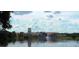 Picturesque waterfront community with beautiful architecture reflected in the serene lake at 516 Millifiora Ln, Kissimmee, FL 34759