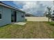 Backyard with a newly installed fence, grassy area, and patio at 522 Feltrim Manor Rd, Haines City, FL 33844