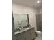 Bathroom featuring double vanity with granite top, toilet, and glass shower at 522 Feltrim Manor Rd, Haines City, FL 33844