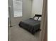 Cozy bedroom featuring plush carpet, a comfortable bed, and ample natural light at 522 Feltrim Manor Rd, Haines City, FL 33844