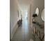 Inviting hallway with stylish console table, round mirrors and a gray sitting chair at 522 Feltrim Manor Rd, Haines City, FL 33844