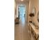 Hallway with tiled floor leading to the living area, and decorative console with vases at 522 Feltrim Manor Rd, Haines City, FL 33844