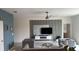 Living room featuring modern furniture, ceiling fan, and entertainment center with accent wall at 522 Feltrim Manor Rd, Haines City, FL 33844