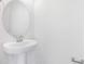 Elegant powder room featuring a pedestal sink and modern fixtures at 530 Summit River Dr, Apopka, FL 32712