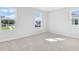 Spacious bedroom with neutral carpet, base molding, and ample natural light from three windows at 530 Summit River Dr, Apopka, FL 32712