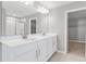 Modern bathroom features a double sink vanity with white countertops and a large mirror with vanity lighting at 540 Summit River Dr, Apopka, FL 32712