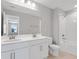 A bathroom boasts dual sinks, a large mirror, and a tub-shower combination, blending style with functionality at 540 Summit River Dr, Apopka, FL 32712