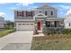 Charming two-story home featuring a red front door, stone accents, neutral siding, and a well-manicured lawn at 540 Summit River Dr, Apopka, FL 32712