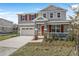 Charming two-story home featuring a red front door, stone accents, neutral siding, and a well-manicured lawn at 540 Summit River Dr, Apopka, FL 32712