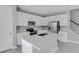 Modern kitchen with white cabinets, stainless steel appliances, large island, and tile flooring at 540 Summit River Dr, Apopka, FL 32712