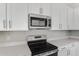 Modern kitchen with stainless steel appliances, sleek countertops, and classic white cabinetry at 540 Summit River Dr, Apopka, FL 32712