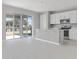 This kitchen features white cabinets, an island, stainless steel appliances, and sliding door to the patio at 540 Summit River Dr, Apopka, FL 32712