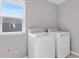 Laundry room featuring a washer and dryer and convenient overhead shelving at 540 Summit River Dr, Apopka, FL 32712
