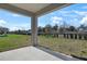 A covered patio offers an outdoor space overlooking a fenced backyard, perfect for relaxation and entertainment at 540 Summit River Dr, Apopka, FL 32712