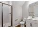 A modern bathroom with wood-look tile, white vanity, toilet and tiled glass shower at 545 Summit River Dr, Apopka, FL 32712