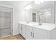 Bathroom featuring double sink vanity with modern fixtures and a glass shower with a walk-in closet at 545 Summit River Dr, Apopka, FL 32712