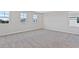 Spacious bedroom with plush carpeting and bright natural light from three large windows at 545 Summit River Dr, Apopka, FL 32712