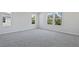 Bright bedroom with soft carpeting and natural light from three windows that bring the outdoors in at 545 Summit River Dr, Apopka, FL 32712