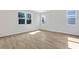 A bedroom with light brown wood look tile, white paint, and windows overlooking the neighborhood at 545 Summit River Dr, Apopka, FL 32712