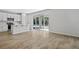 A large living area with wood look tile, white paint, and a sliding glass doors to the backyard at 545 Summit River Dr, Apopka, FL 32712