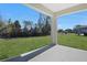 Covered patio with expansive green lawn, perfect for entertaining and enjoying the outdoors at 545 Summit River Dr, Apopka, FL 32712