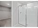 Bathroom featuring a glass-enclosed shower with tiled walls and a view of a walk-in closet at 555 Summit River Dr, Apopka, FL 32712