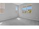Bright bedroom with plush gray carpet and several windows, offering lots of natural light at 555 Summit River Dr, Apopka, FL 32712