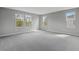 Spacious bedroom featuring plush carpeting and abundant natural light from multiple windows at 555 Summit River Dr, Apopka, FL 32712