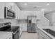 Modern kitchen featuring stainless steel appliances, white cabinets, and an island sink at 555 Summit River Dr, Apopka, FL 32712