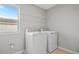Convenient laundry room equipped with a washer, dryer, and overhead shelving for storage at 555 Summit River Dr, Apopka, FL 32712