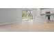 Open floor plan living room with sliding glass doors and bar seating to kitchen at 555 Summit River Dr, Apopka, FL 32712
