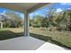 Covered patio overlooking a lush backyard, perfect for outdoor relaxation at 555 Summit River Dr, Apopka, FL 32712