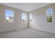 Bright bedroom with neutral carpet and plenty of natural light from three windows at 565 Summit River Dr, Apopka, FL 32712