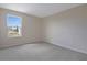 A carpeted bedroom with a single window letting in natural light at 565 Summit River Dr, Apopka, FL 32712