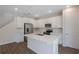 Modern kitchen featuring white cabinets, stainless steel appliances, and a large center island at 565 Summit River Dr, Apopka, FL 32712