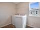 Laundry room featuring tile flooring, a wire shelf, and front load washer and dryer at 565 Summit River Dr, Apopka, FL 32712